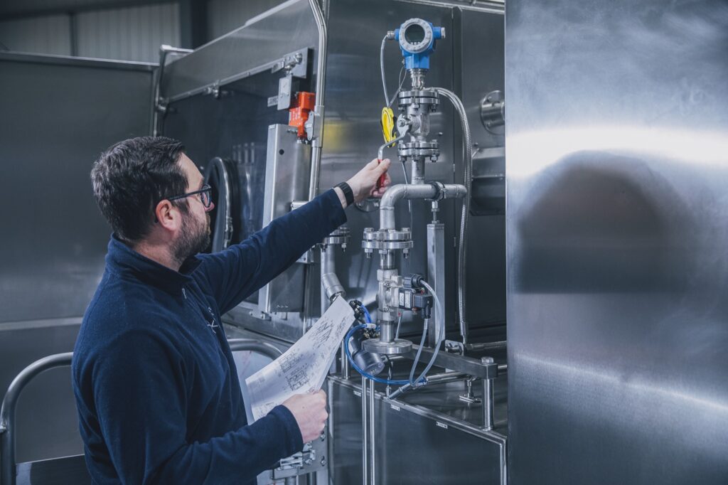 An engineer inspects a machine