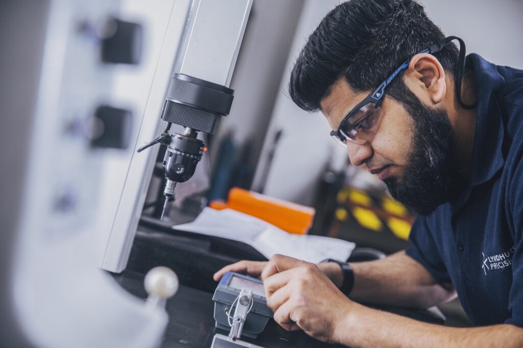 An engineer inspects a component